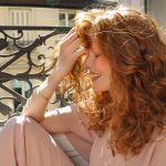 side profile of ginger haired women smiling
