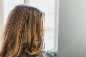 Girl with brunette hair sitting in a salon chair