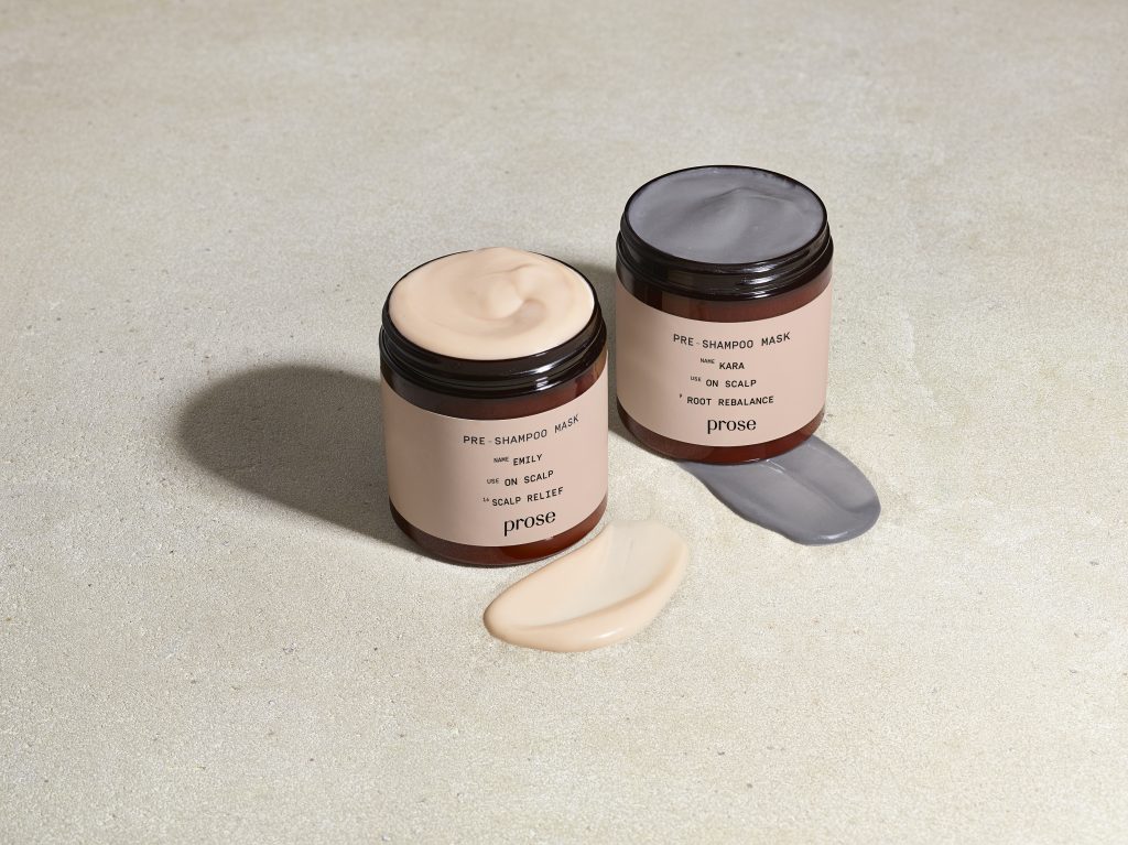 the Prose charcoal and grapefruit scalp mask sit next to each other with their lids open