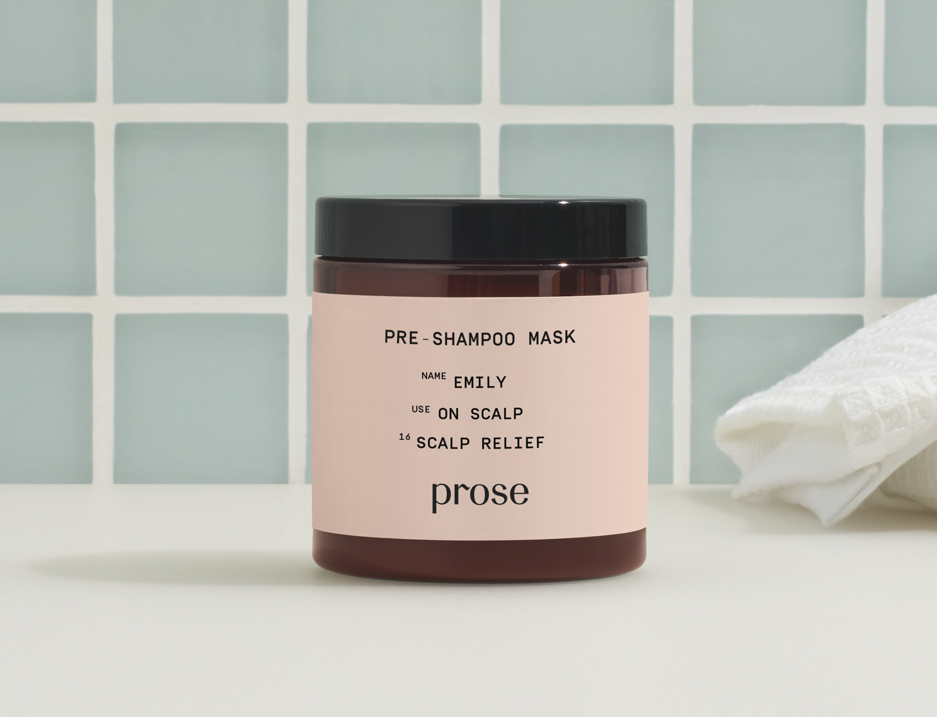 prose scalp mask sits on a bathroom counter with sea foam green tile in the background