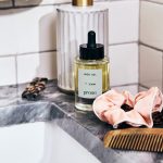 prose custom hair oil sits on a marble sink