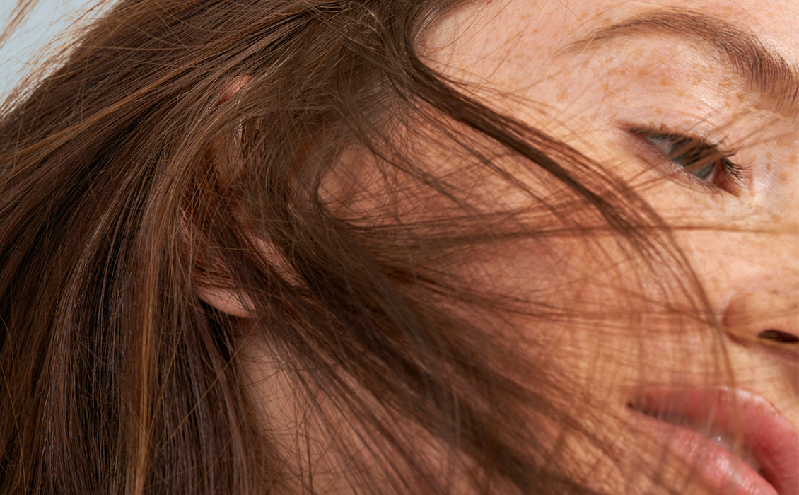 close up portrait of woman with freckles and auburn hair