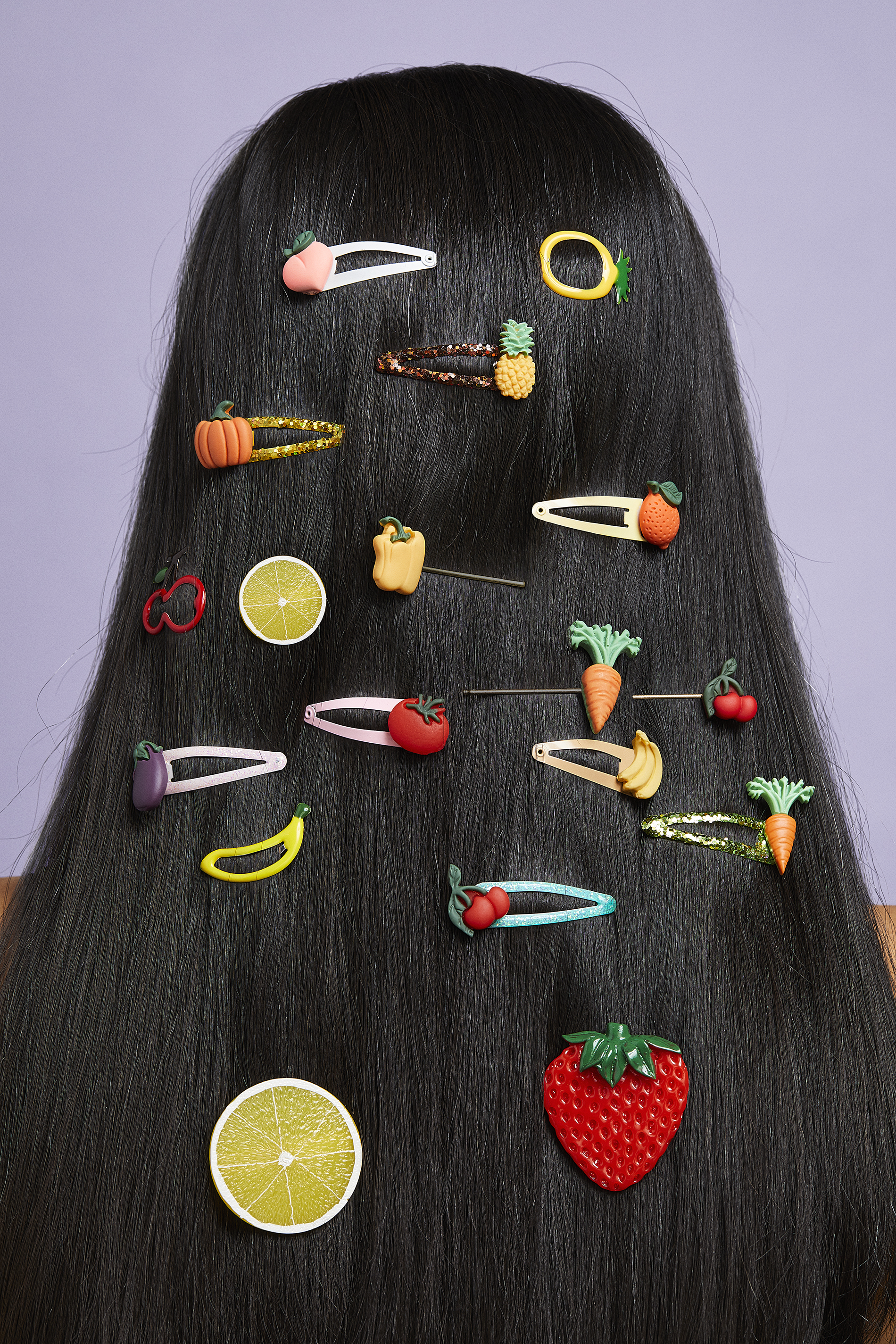 woman with long, black, straight hair with fruit barrettes in her hair