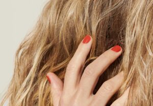 woman touching her blonde hair