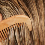 woman combing through blonde hair