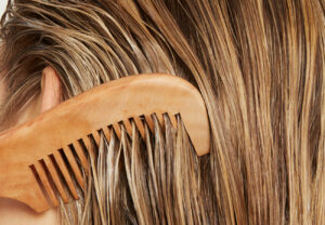 woman combing through blonde hair