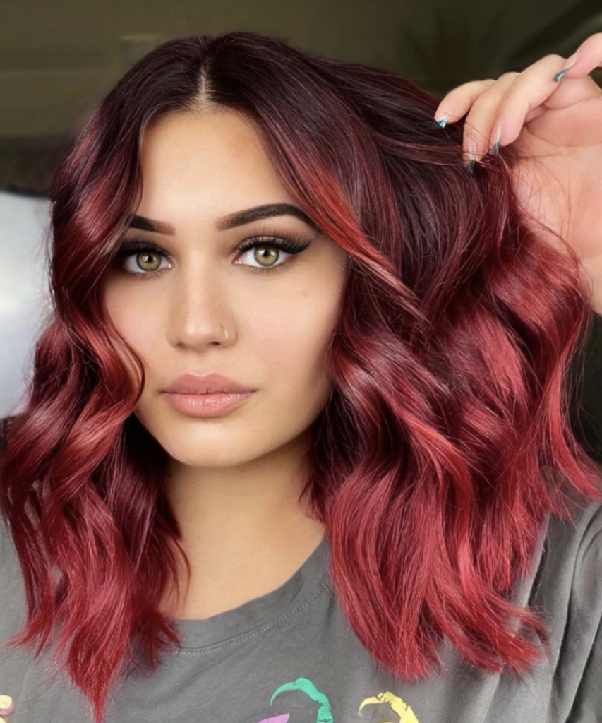 woman with bright red balayage hair color
