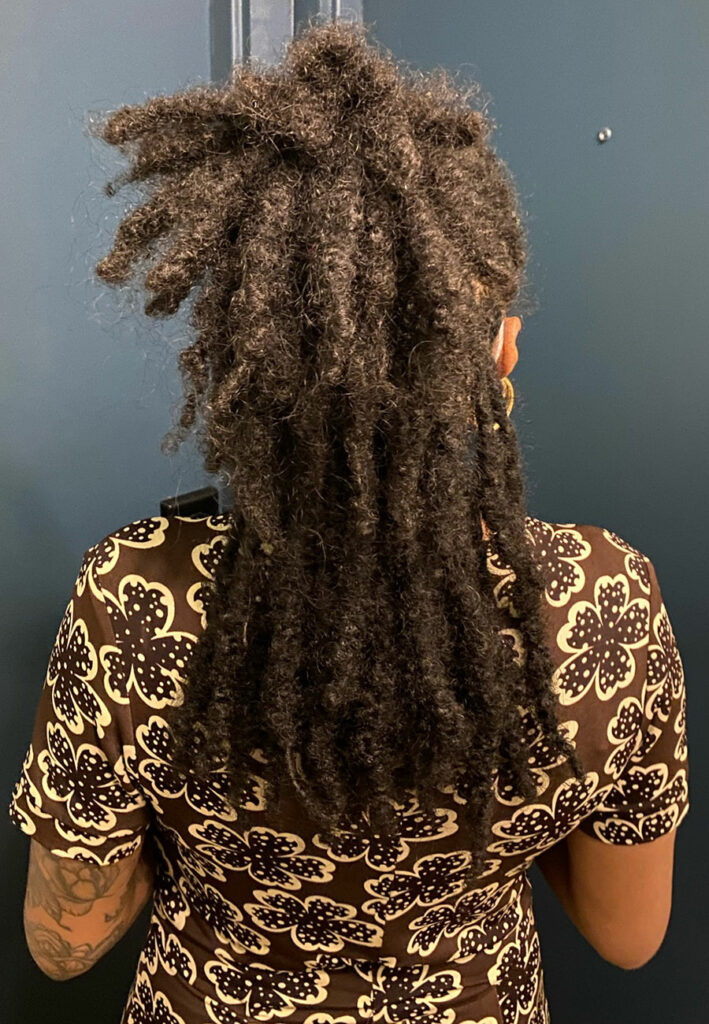 The back of Priscilla's head showing how long her locs are