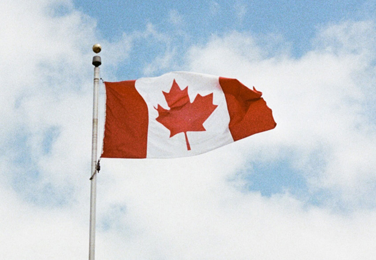 Canadian flag against a sky background