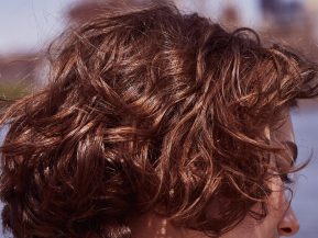 Prose model with short brown, wavy hair close up
