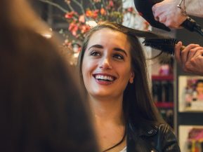 Woman getting her hair styled at a hair salon.