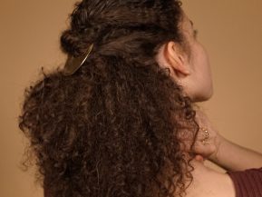 Woman with natural curly hair in half-up ponytail