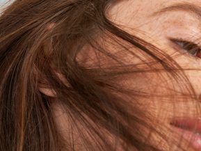 close up portrait of woman with freckles and auburn hair