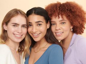 three young women smiling